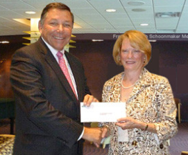 Ken Chevern, President of the St. Petersburg College Foundation’s Board of Directors and President of the Pinellas Division of Bank of Tampa receives a check from Julie Scales, Executive Director of the Pinellas Community Foundation, for matching funds under the State of Florida’s First Generation Scholarship Program.